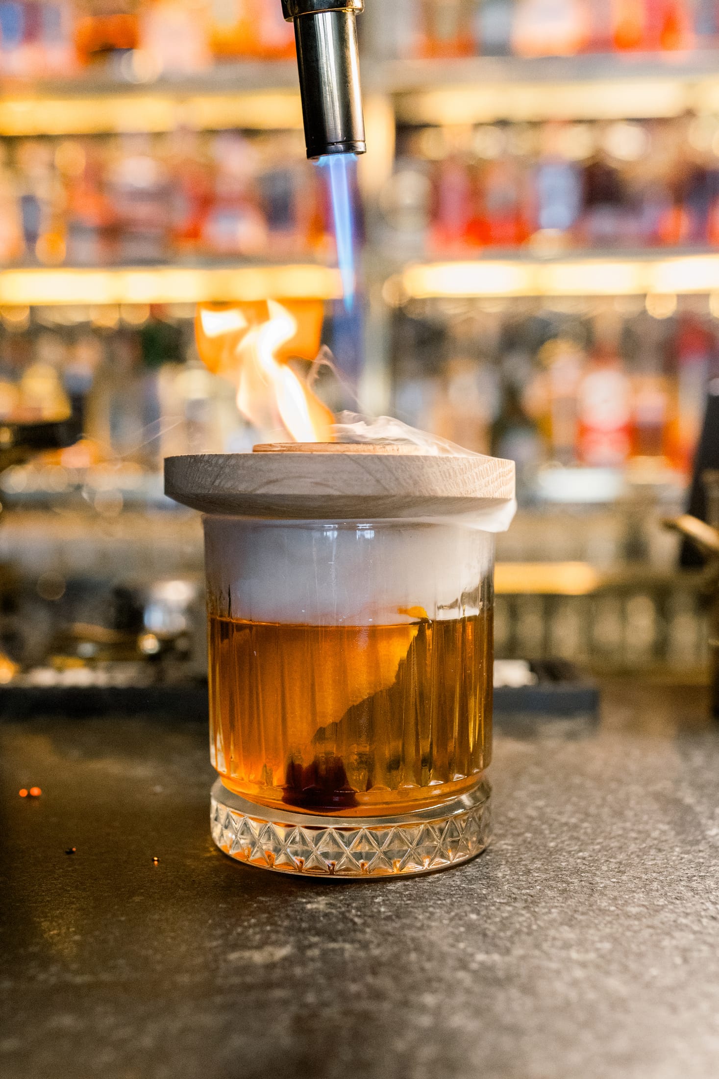 A Sentinel smoker in use over a cocktail at the bar
